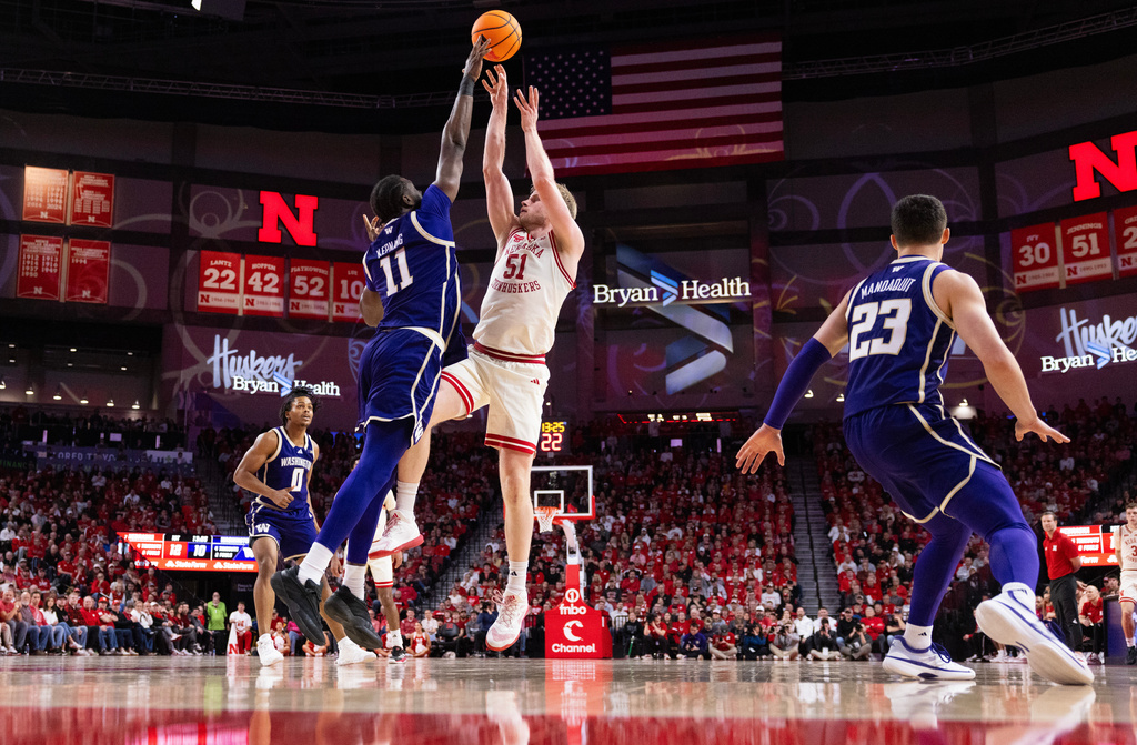 Nebraska's Rienk Mast (51) shoots against Washington's Franck Kepnang (11) during the first half of an NCAA college basketball game Wednesday, Jan. 21, 2026, in Lincoln, Neb. (AP Photo/Rebecca S. Gratz)
