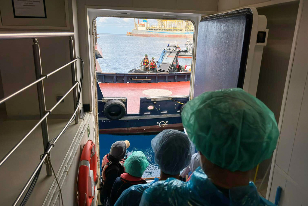 Passengers are being disembarked from the hantavirus-stricken cruise ship MV Hondius at the port of Granadilla in Tenerife, Canary Islands, Spain, Sunday, May 10, 2026. (AP Photo)