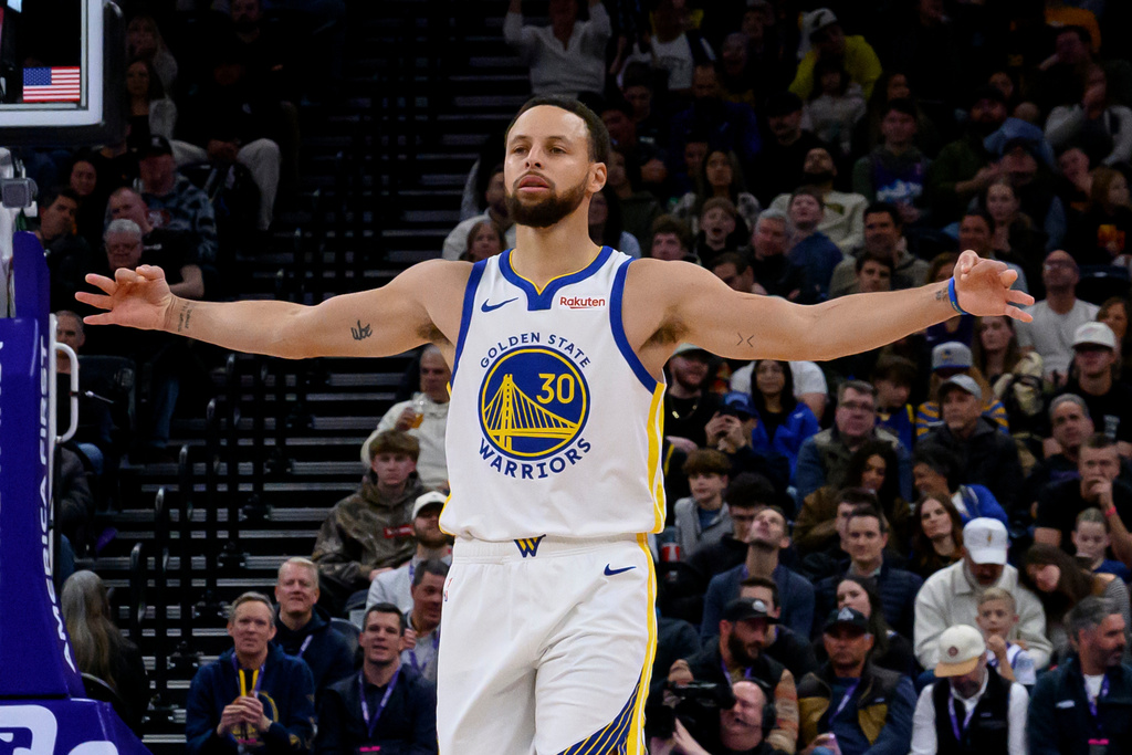 Golden State Warriors guard Stephen Curry celebrates scoring a three point shot during the second half of an NBA basketball game against the Utah Jazz, Wednesday, Jan. 28, 2026, in Salt Lake City. (AP Photo/Tyler Tate)