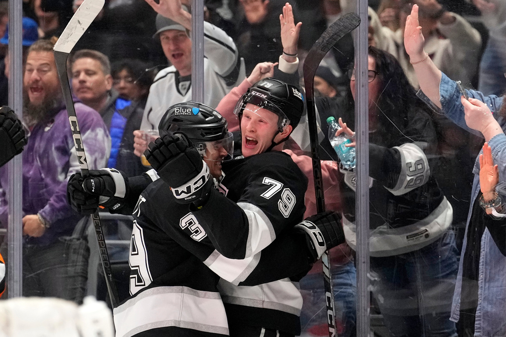 Los Angeles Kings center Samuel Helenius, right, celebrates his goal with left wing Jeff Malott during the second period of an NHL hockey game against the New York Islanders, Thursday, March 5, 2026, in Los Angeles. (AP Photo/Mark J. Terrill)