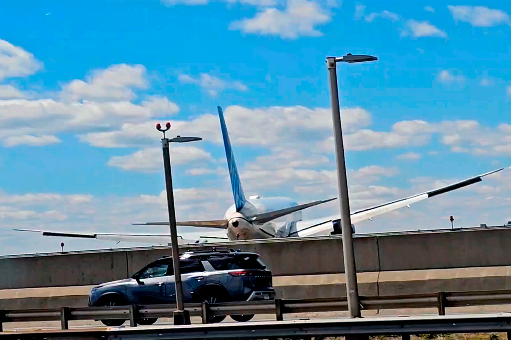FILE - A United Airlines plane is seen in a still image taken from video after hitting a light pole on the New Jersey Turnpike as it lands at Newark Liberty International Airport, Sunday, May 3, 2026. (Patrick Oyulu, via AP)