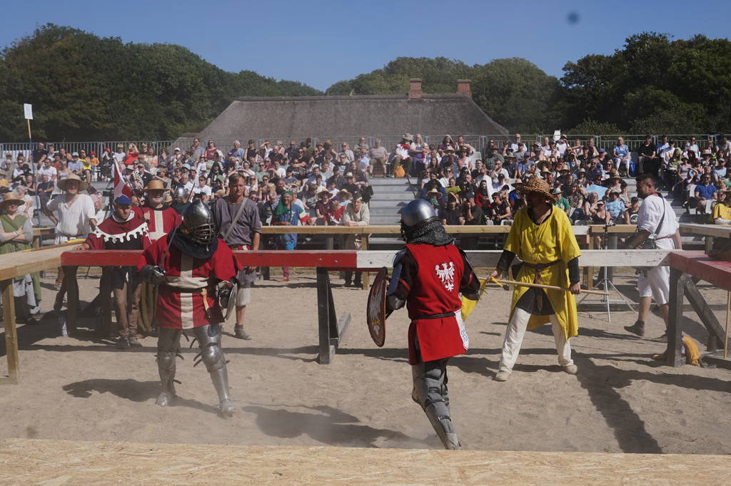 Two fighters battle during the International Medieval Combat Federation's World Championship at Spottrup Castle, in Spottrup, Denmark, Thursday, July 23, 2026. (AP Photo/James Brooks)