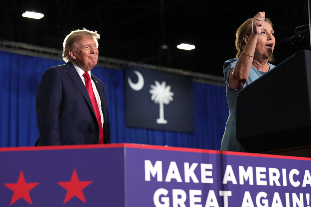 President Donald Trump listens as Sen. Darline Graham, R-S.C., speaks during her campaign rally at the Myrtle Beach Convention Center in Myrtle Beach, S.C., Friday, Aug. 21, 2026. (AP Photo/Jacquelyn Martin)