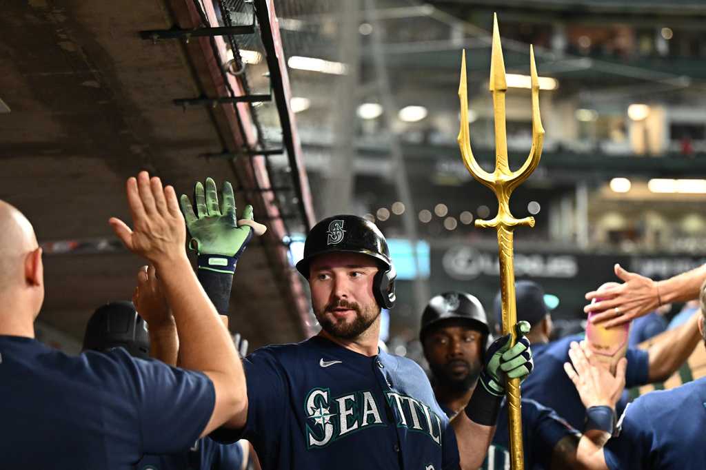 Seattle Mariners' Cal Raleigh, center, is greeted by teammates after hitting a three-run home run during the fourth inning of a baseball game against the Los Angeles Angels, Monday, Sept. 14, 2026, in Anaheim, Calif. (AP Photo/William Liang)