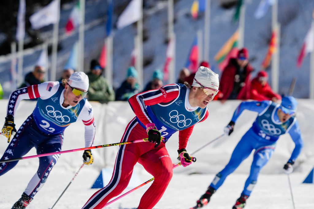 Johannes Hoesflot Klaebo, of Norway, Gus Schumacher, of the United States, left, and Federico Pellegrino, of Italy, right, compete in the cross-country skiing men's team sprint free at the 2026 Winter Olympics, in Tesero, Italy, Wednesday, Feb. 18, 2026. (AP Photo/Evgeniy Maloletka)