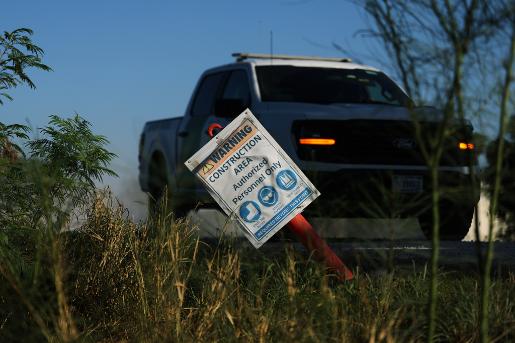 A U.S. Border Patrol passes a construction sign for a new section of border wall at the Santa Ana Wildlife Refuge in Alamo, Texas, Tuesday, Aug. 25, 2026. (AP Photo/Eric Gay)