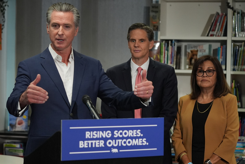 California Gov. Gavin Newsom speaks about legislation related to student literacy with Marshall Tuck, EdVoice CEO, middle, and Martha Hernandez, Executive Director, Californians Together in Los Angeles on Thursday, Oct. 9, 2025. (AP Photo/Damian Dovarganes)