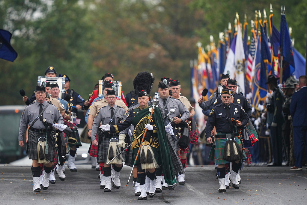 A procession passes for slain Northern York County Regional Police detectives Cody Michael Becker, Mark Edward Baker and Isaiah Emenheiser, Thursday, Sept. 25, 2025, in Red Lion, Pa. (AP Photo/Matt Rourke)