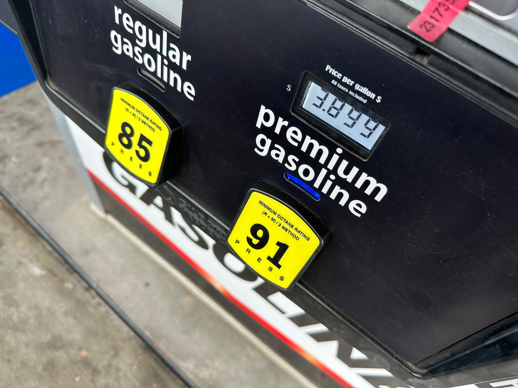 The per-gallon price for premium unleaded fuel is displayed electronically on a pump at a Costco gosoline station Thursday, March 12, 2026, in east Denver. (AP Photo/David Zalubowski)