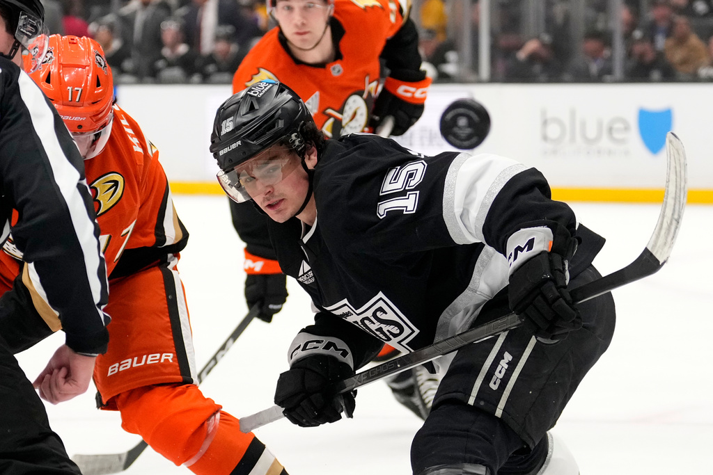 Los Angeles Kings center Alex Turcotte, right, watches the puck fly away during a face off with Anaheim Ducks left wing Alex Killorn, left, during the first period of an NHL hockey game Friday, Jan. 16, 2026, in Los Angeles. (AP Photo/Mark J. Terrill)