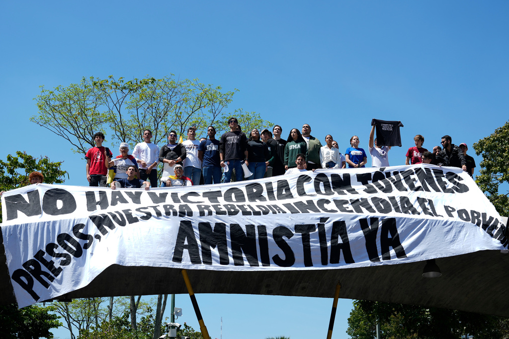 People attend a student-led march on National Youth Day to call for the release of detainees, considered to be political prisoners by their relatives and human rights groups, in Caracas, Venezuela, Thursday, Feb. 12, 2026. (AP Photo/Ariana Cubillos)