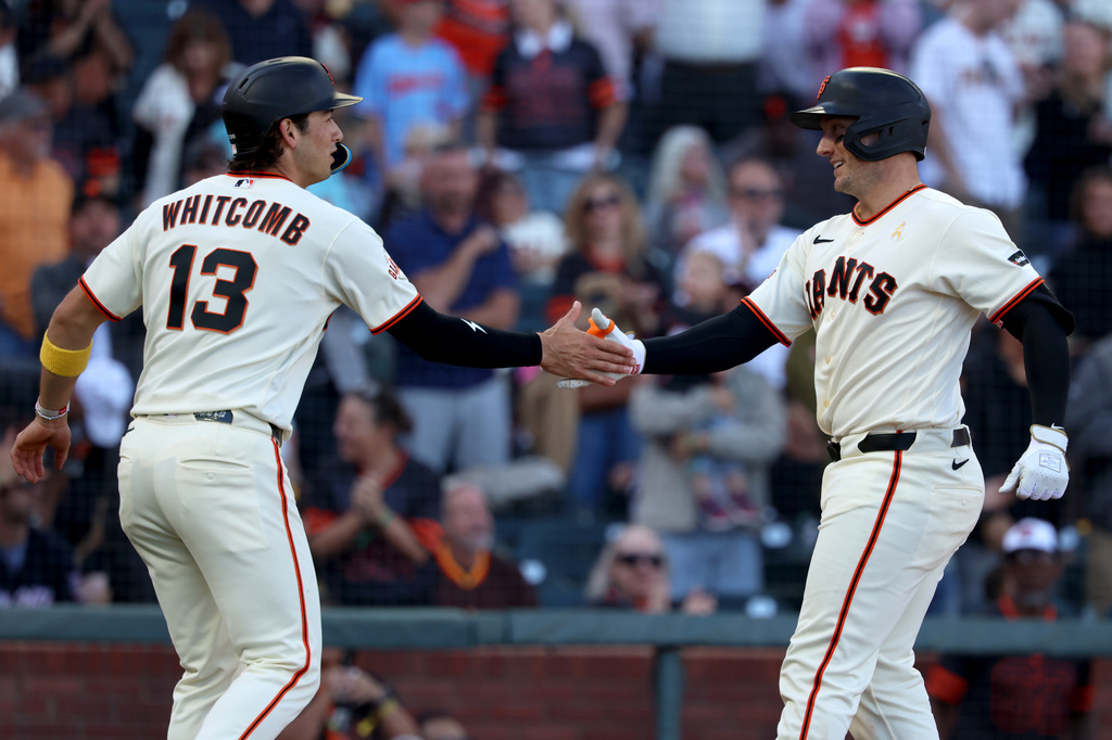 San Francisco Giants' Andrew Knizner, right, celebrates with Shay Whitcomb (13) after hitting a home run during the second inning of a baseball game against the San Diego Padres in San Francisco, Sunday, Sept. 13, 2026. (AP Photo/Jed Jacobsohn)