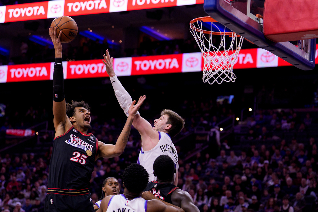 Philadelphia 76ers' Dom Barlow, left, shoots the ball against Utah Jazz's Kyle Filipowski, right, during the first half of an NBA basketball game, Wednesday, March 4, 2026, in Philadelphia. (AP Photo/Chris Szagola)