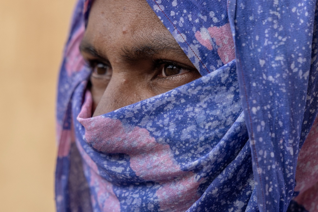 A Malian woman, whose 14-year-old niece was abused by Africa Corps Russian mercenaries in Mali, waits outside the Bassikounou hospital where her niece is being treated in the Hodh El Chargui Region, where they found refuge, in Mauritania, Nov. 7, 2025. (AP Photo/Caitlin Kelly)