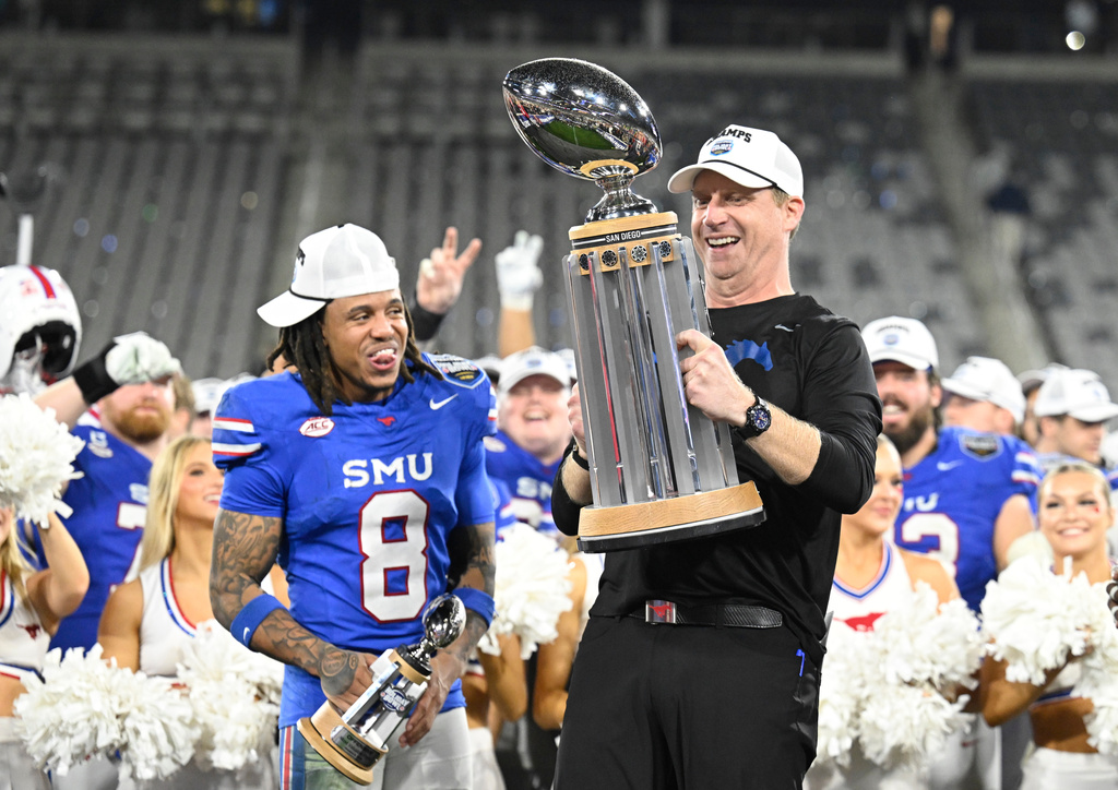 SMU head coach Rhett Lashlee, right, and Yamir Knight (8) celebrate after SMU beat Arizona in the Holiday Bowl NCAA college football game Friday, Jan. 2, 2026, in San Diego. (AP Photo/Denis Poroy)