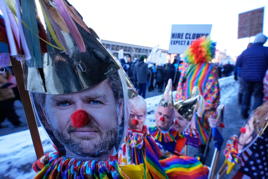 Photos of Vice President JD Vance, left, and other members of the Trump administration dressed as clowns are seen during a protest Friday, Jan. 30, 2026, in Minneapolis. (AP Photo/Alex Brandon)