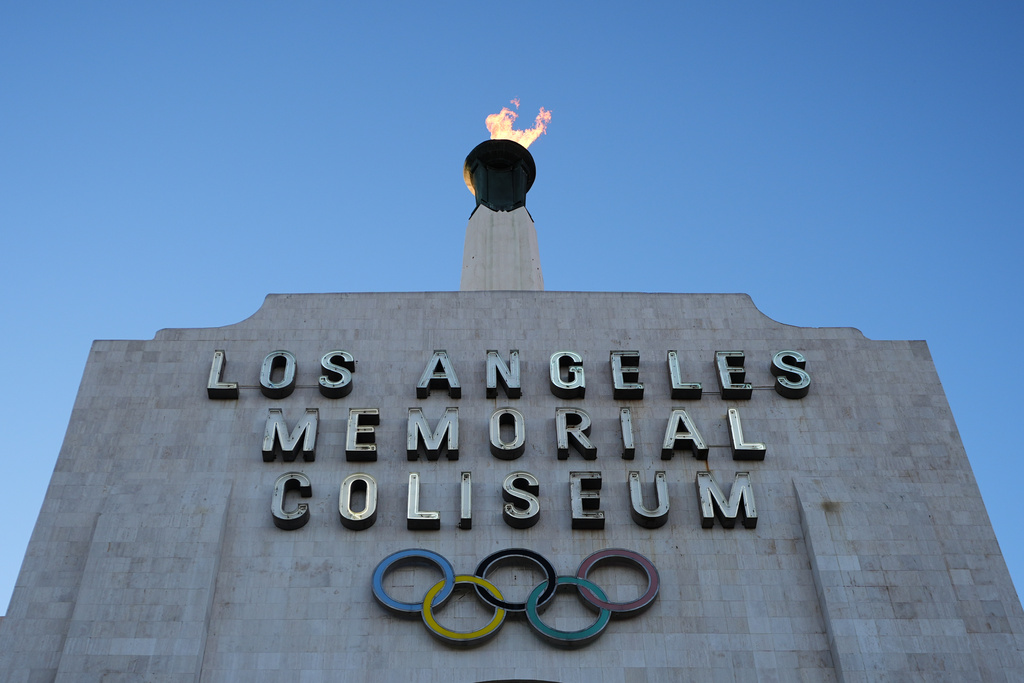 The Olympic cauldron is lit at the Los Angeles Memorial Coliseum ahead of the launch for ticket registration to the 2028 Summer Olympic Games Tuesday, Jan. 13, 2026, in Los Angeles. (AP Photo/Damian Dovarganes)