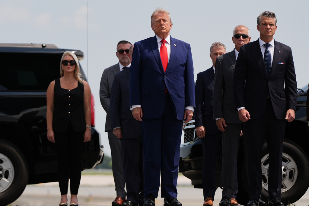 President Donald Trump, center, White House press secretary Karoline Leavitt, back left, and Defense Secretary Pete Hegseth, right, attend the dignified transfer of four U.S. service members recently killed in the Middle East, Wednesday, July 22, 2026, at Dover Air Force Base, Del. (AP Photo/Julia Demaree Nikhinson)