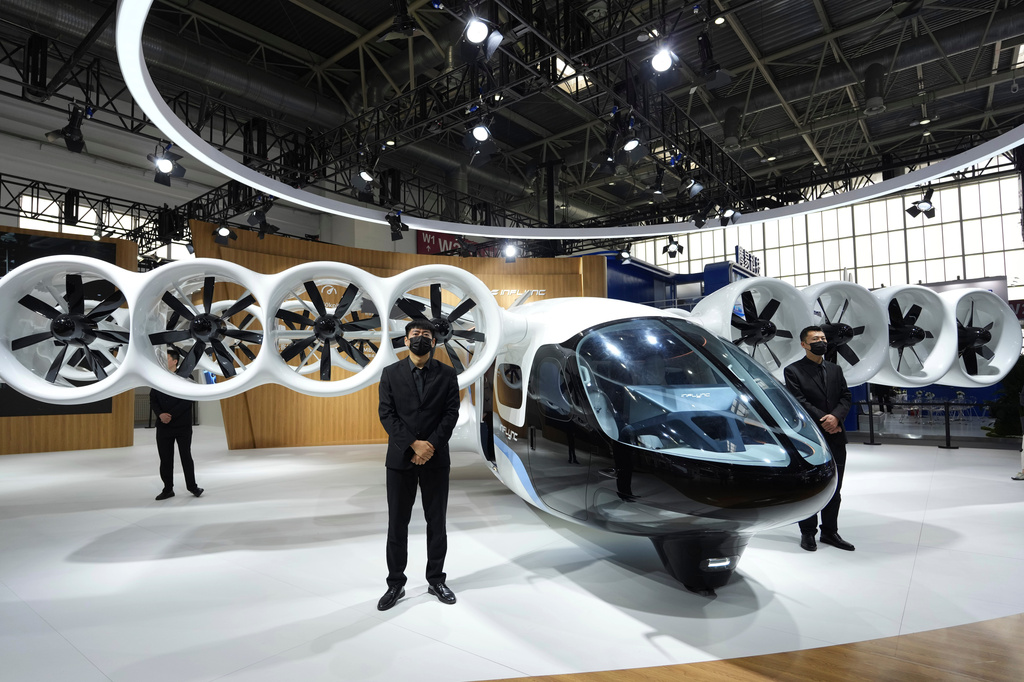 Security personnel stand around the L600 prototype flying vehicle from INFLYNC during Auto China 2026 in Beijing, Saturday, April 25, 2026. (AP Photo/Ng Han Guan)