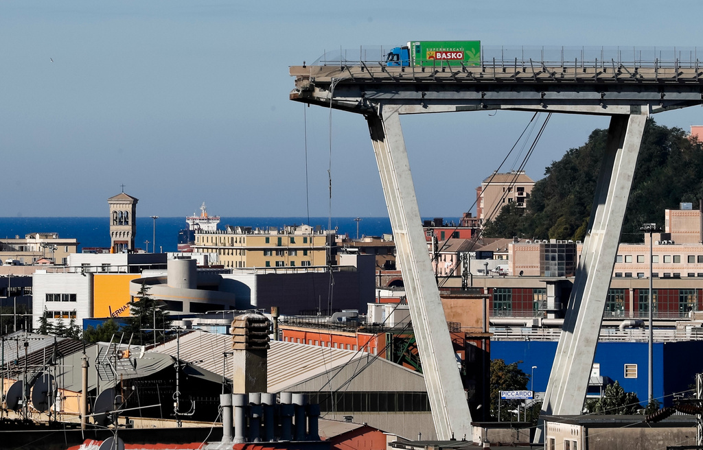 FILE - A vehicle sits short of a section of the Morandi highway bridge that collapsed on Aug. 15, 2018, in Genoa, northern Italy. (AP Photo/Antonio Calanni, File)