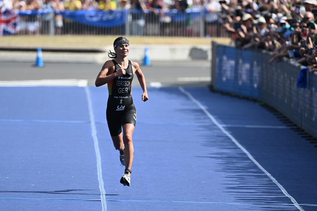Lisa Tertsch of Germany runs to the finish line as she wins the Elite Women's final at the World Triathlon Championships in Wollongong, Australia, Sunday, Oct. 19, 2025. (Dean Lewins/AAPImage via AP)