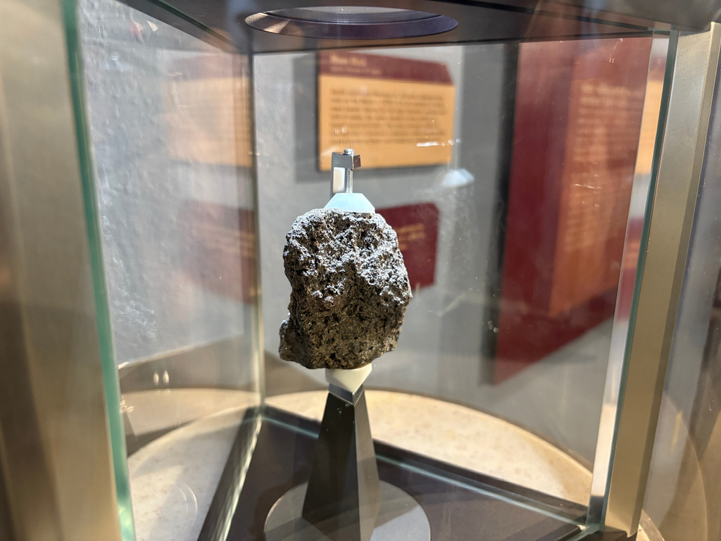 A moon rock collected by Apollo astronaut Harrison "Jack" Schmitt in 1972 is displayed at the New Mexico Museum of Natural History and Science in Albuquerque, N.M., on April 22, 2026. (AP Photo/Susan Montoya Bryan)