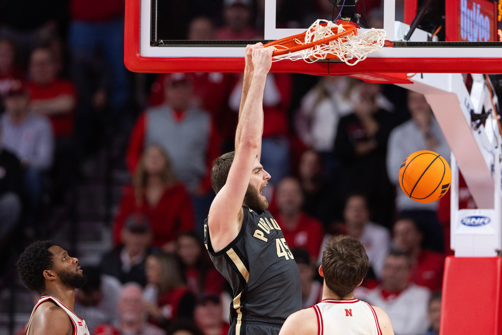 Purdue's Oscar Cluff, center, dunks against Nebraska's Jared Garcia, left, and Pryce Sandfort during the first half of an NCAA college basketball game Tuesday, Feb. 10, 2026, in Lincoln, Neb. (AP Photo/Rebecca S. Gratz)
