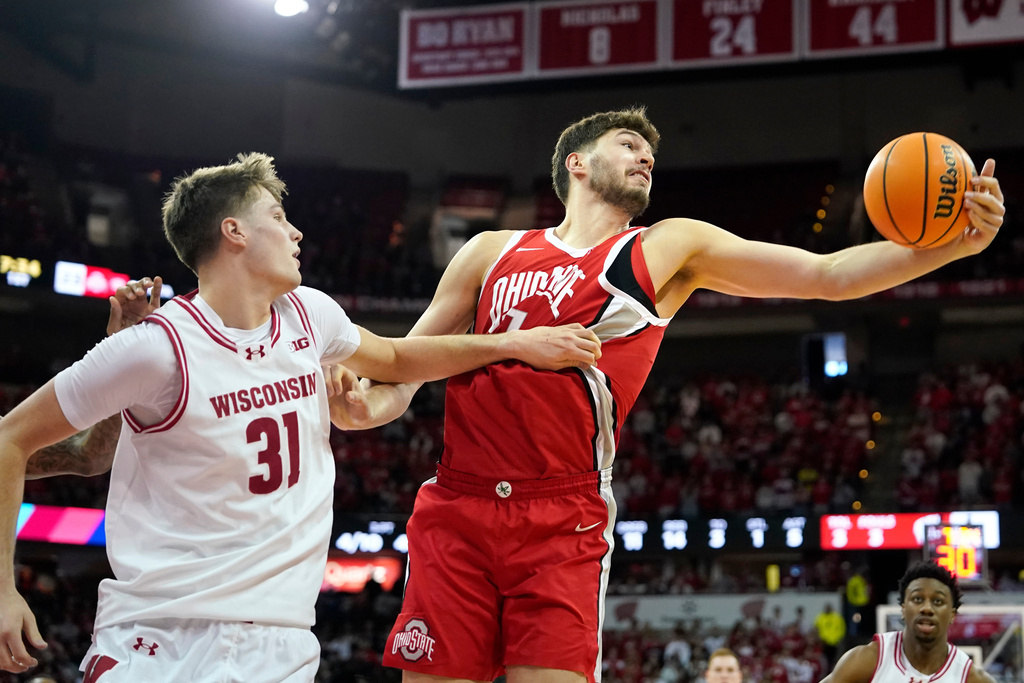 Ohio State center Ivan Njegovan, right, rebounds the ball against Wisconsin forward Nolan Winter (31) during the first half of an NCAA college basketball game Saturday, Jan. 31, 2026, in Madison, Wis. (AP Photo/Kayla Wolf)