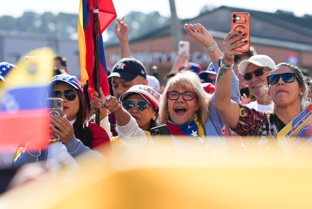 People gather to celebrate the deposing of Venezuelan President Nicolás Maduro, Sunday, Jan. 4, 2026, in Katy, Texas. (Elizabeth Conley/Houston Chronicle via AP)