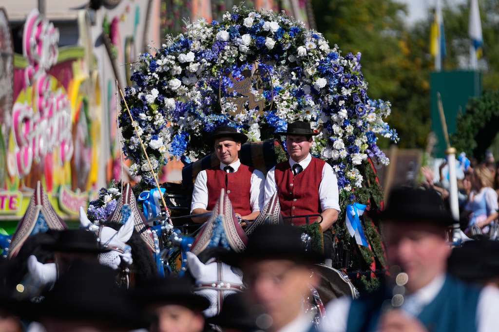 People wear traditional costumes in the Oktoberfest parade at the 191st Oktoberfest beer festival in Munich, Germany, Saturday, Sept.19, 2026. (AP Photo/Matthias Schrader)