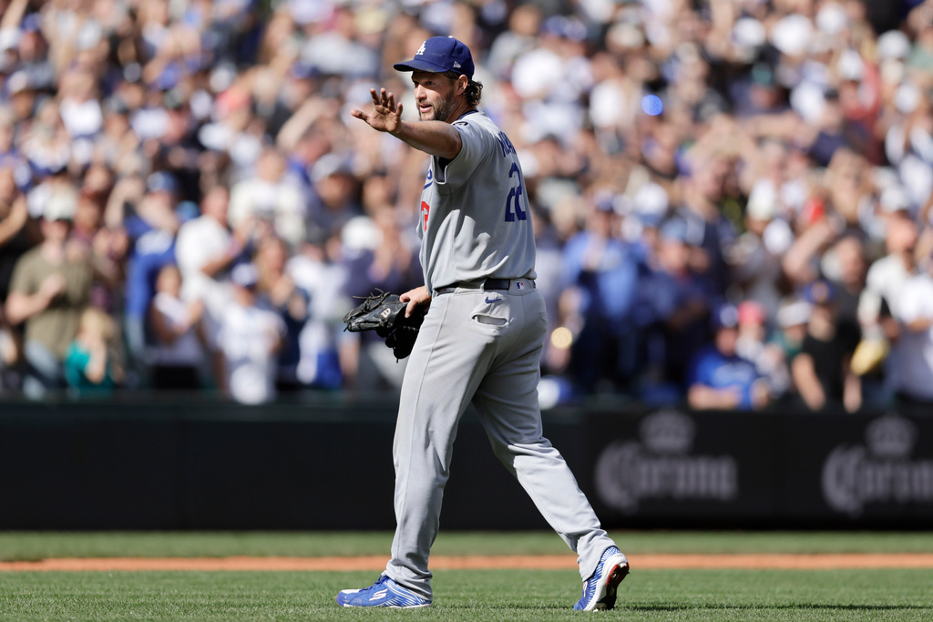 Los Angeles Dodgers pitcher Clayton Kershaw waves as he leaves during the sixth inning of a baseball game against the Seattle Mariners, Sunday, Sept. 28, 2025, in Seattle. (AP Photo/John Froschauer)