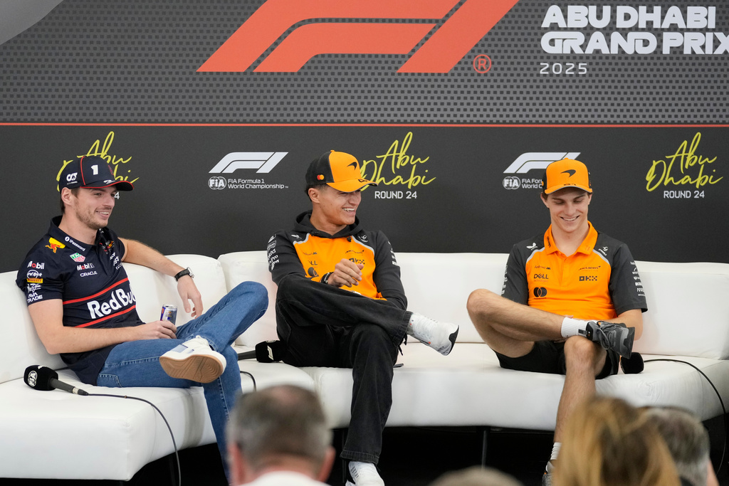 From left: Red Bull driver Max Verstappen of the Netherlands, McLaren driver Lando Norris of Britain, and McLaren driver Oscar Piastri of Australia attend a news conference ahead of the Abu Dhabi Grand Prix in Abu Dhabi, United Arab Emirates, Thursday, Dec. 4, 2025. (AP Photo/Darko Bandic)