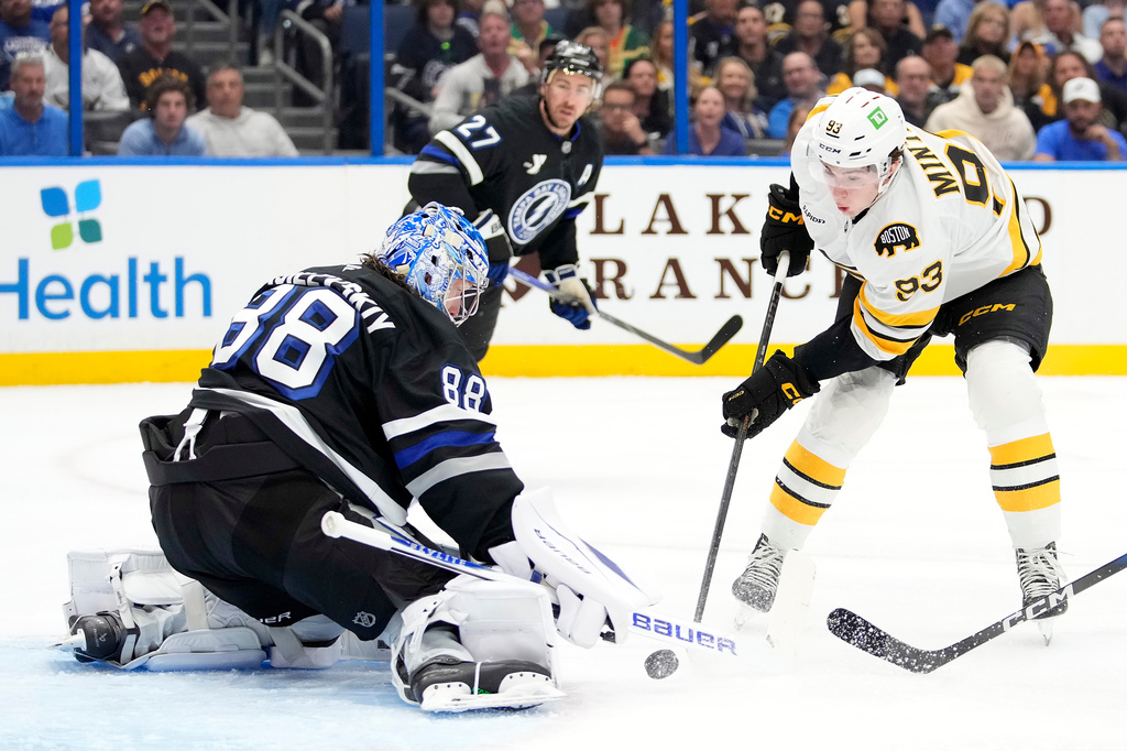 Tampa Bay Lightning goaltender Andrei Vasilevskiy (88) stops a shot by Boston Bruins center Fraser Minten (93) stops a shot by during the first period of an NHL hockey game Saturday, April 4, 2026, in Tampa, Fla. (AP Photo/Chris O'Meara)