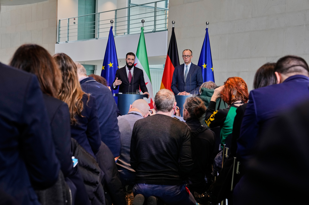 German Chancellor Friedrich Merz, right, and Syrian President Ahmad al-Sharaa attend a press conference in Berlin, Germany, Monday, March 30, 2026. (AP Photo/Markus Schreiber)
