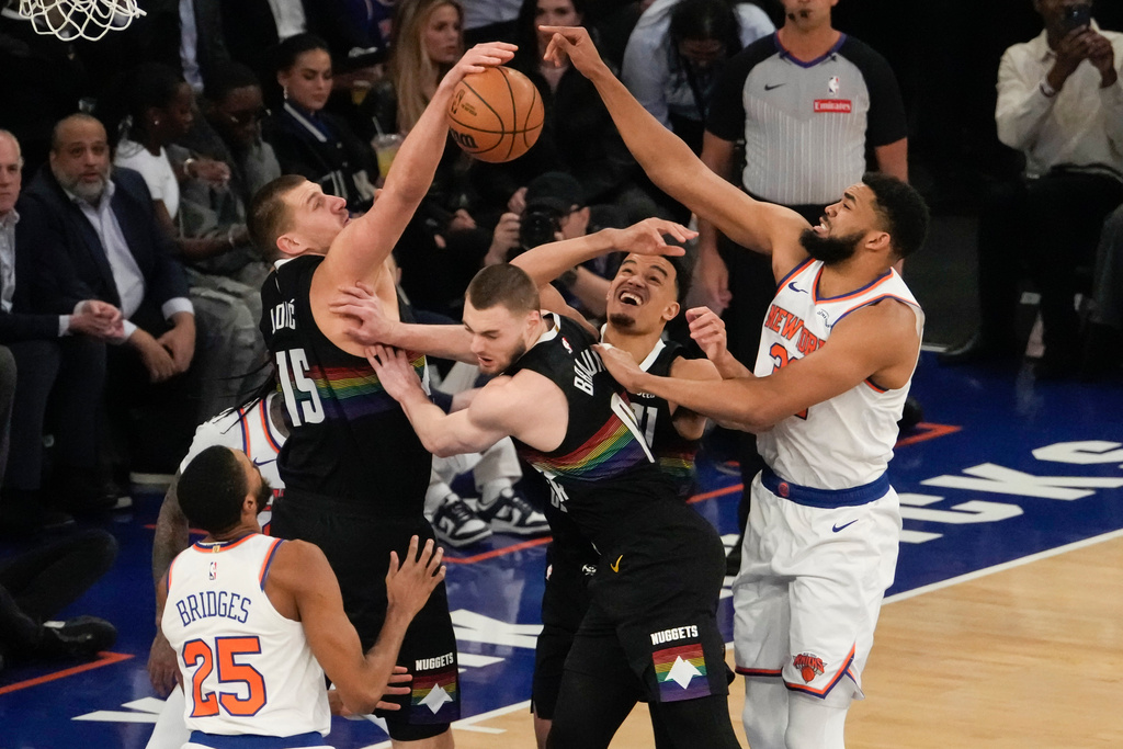 Denver Nuggets center Nikola Jokic (15) fights for control of the ball with New York Knicks center Karl-Anthony Towns (32) during the first half of an NBA basketball game, Wednesday, Feb. 4, 2026, in New York. (AP Photo/Yuki Iwamura)