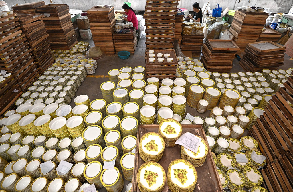 Workers labor at a ceramic ware factory, in Handan in north China's Hebei province on Nov. 4, 2025. (Chinatopix Via AP)