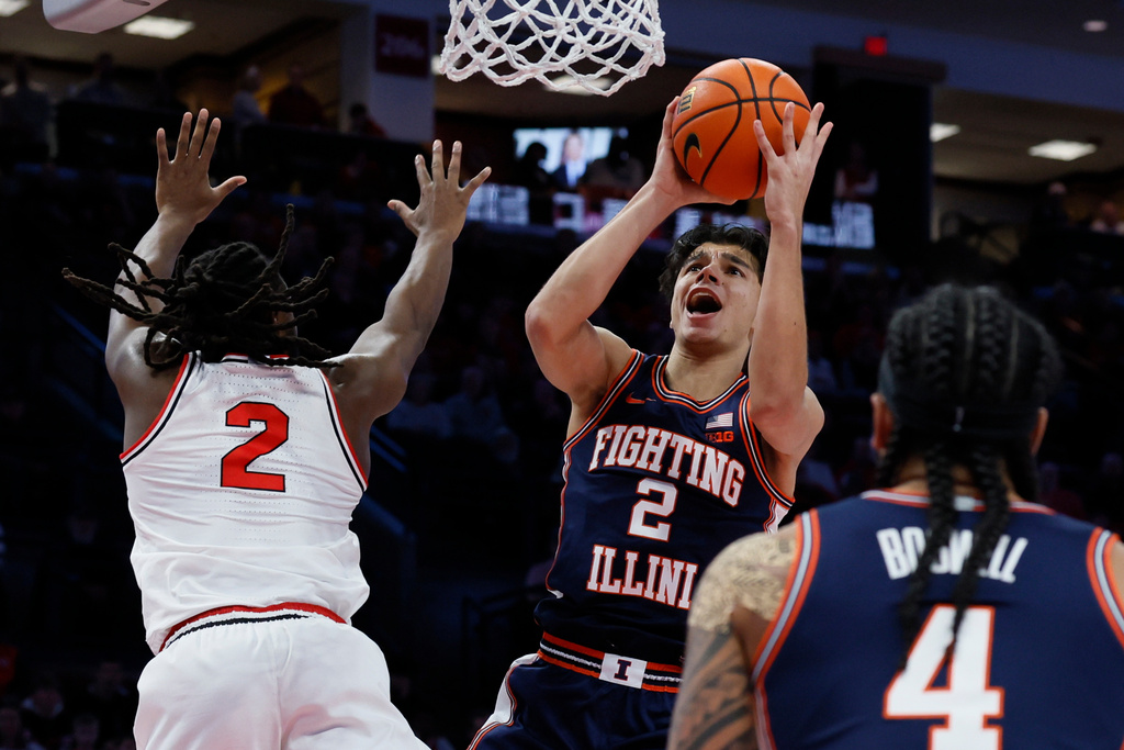 Illinois' Andrej Stojakovic, right, shoots over Ohio State's Bruce Thornton during the first half of an NCAA college basketball game, Tuesday, Dec. 9, 2025, in Columbus, Ohio. (AP Photo/Jay LaPrete)