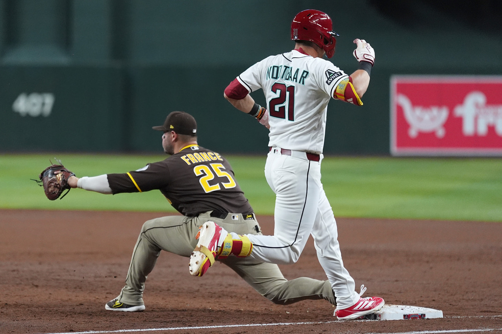San Diego Padres first baseman Ty France (25) makes a catch at first base for an out against Arizona Diamondbacks' Lars Nootbaar (21) during the second inning of a baseball game, Tuesday, Aug. 4, 2026, in Phoenix. (AP Photo/Ross D. Franklin)