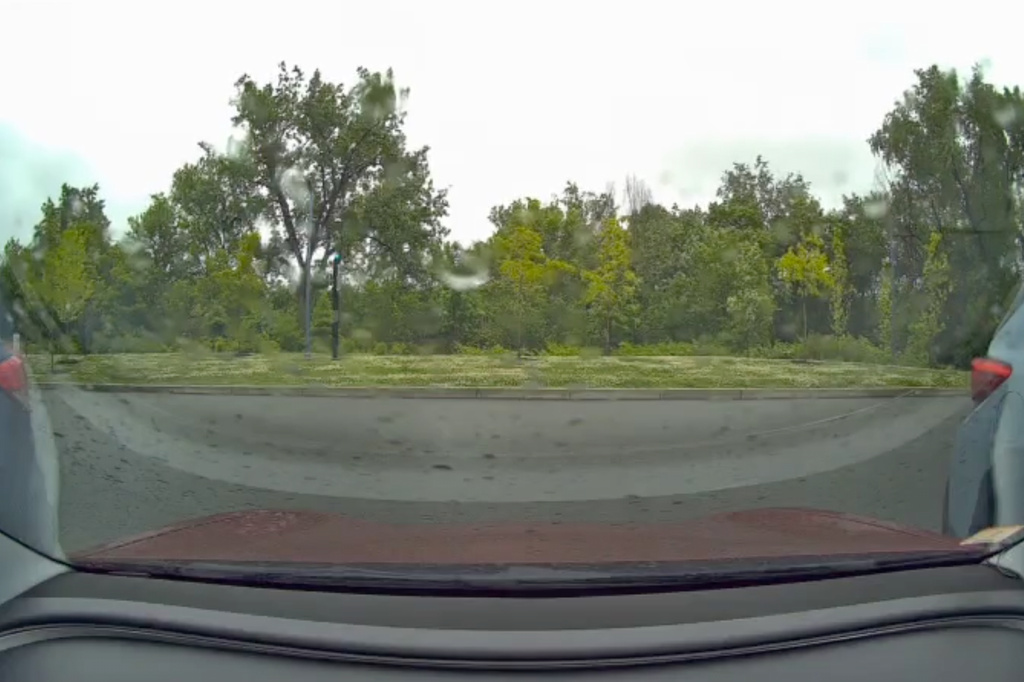 This image taken from video shows a view from a car dashcam when a meteor produced two loud booms over Cambridge, Mass., Saturday, May 30, 2026. (Stanley Fung via AP)