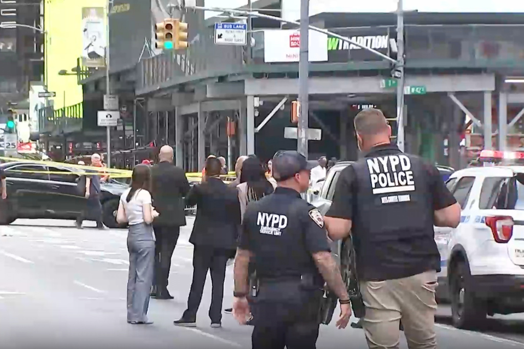 This image made from video provided by WABC shows NYPD officers on the scene after a woman brandishing two large knives was shot by officers in Times Square in New York, Monday, Aug. 31, 2026. (WABC via AP)