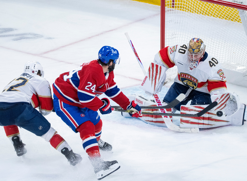 Florida Panthers goaltender Daniil Tarasov (40) makes a save against Montreal Canadiens' Phillip Danault (24) as Panthers' Tobias Bjornfot (22) defends during second period NHL hockey action in Montreal on Tuesday, April 7, 2026. (Christinne Muschi/The Canadian Press via AP)