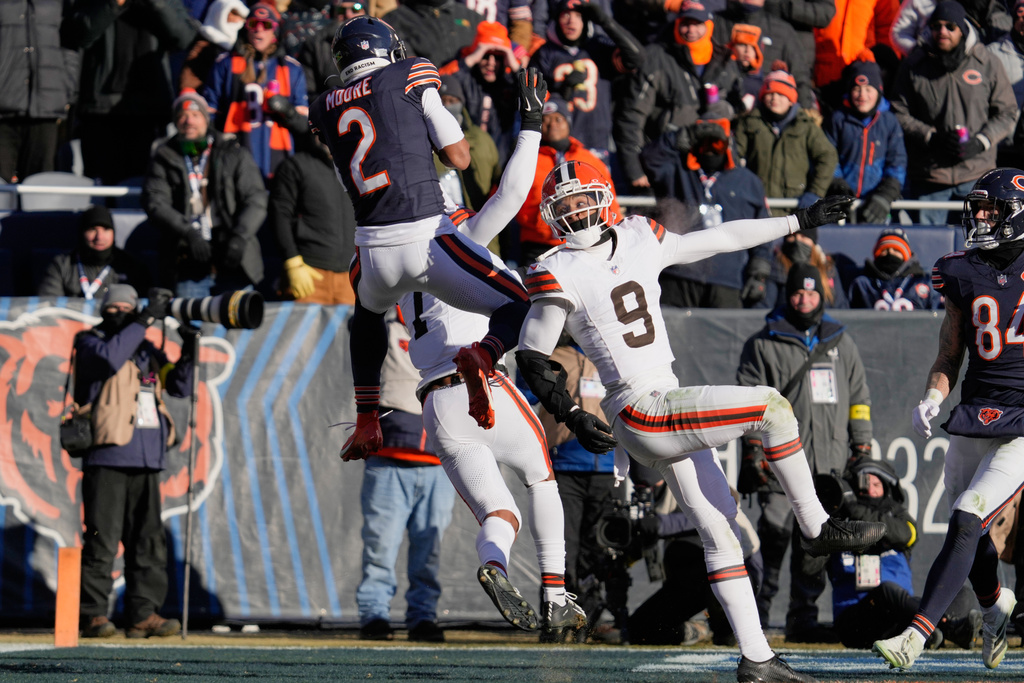 Chicago Bears wide receiver DJ Moore (2) catches a touchdown pass in front of Cleveland Browns safety Grant Delpit (9) in the second half of an NFL football game in Chicago, Sunday, Dec. 14, 2025. (AP Photo/Nam Y. Huh)