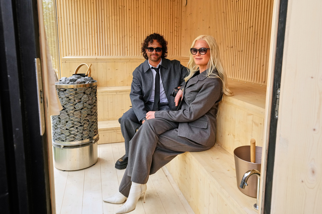 Linda Lampenius and Pete Parkkonen, who compete as Liekinheitin for Finland at the 70th Eurovision Song Contest, sit in a Finnish sauna after an interview with The Associated Press in Vienna, Austria, Thursday, May 14, 2026. (AP Photo/Martin Meissner)