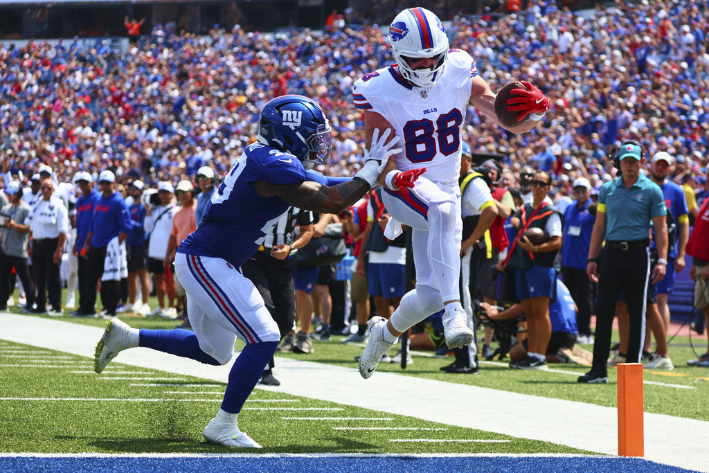 Buffalo Bills' Dawson Knox (88) runs past Buffalo Bills' Keonta Jenkins (49) for a touchdown during the first half of an NFL preseason football game Saturday, Aug. 9, 2025, in Orchard Park, N.Y. (AP Photo/Jeffrey T. Barnes)