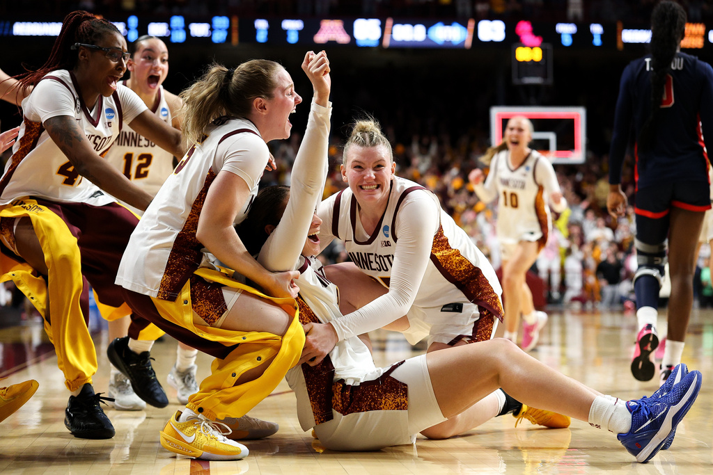 Minnesota guard Amaya Battle, second fron fron right, celebrates after her winning basket against Mississippi during the second half in the second round of the NCAA college basketball tournament, Sunday, March 22, 2026, in Minneapolis. (AP Photo/Matt Krohn)