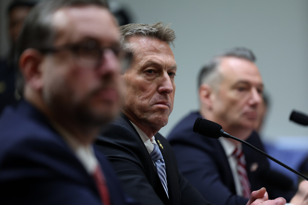 From left, Joseph Edlow, director of U.S. Citizenship and Immigration Services, Rodney Scott, commissioner of the U.S. Customs and Border Protection and Todd Lyons, senior official performing the duties of the director at U.S. Immigration and Customs Enforcement, listen during a Senate Homeland Committee hearing on Capitol Hill in Washington, Thursday, Feb. 12, 2026, in Washington. (AP Photo/Tom Brenner)