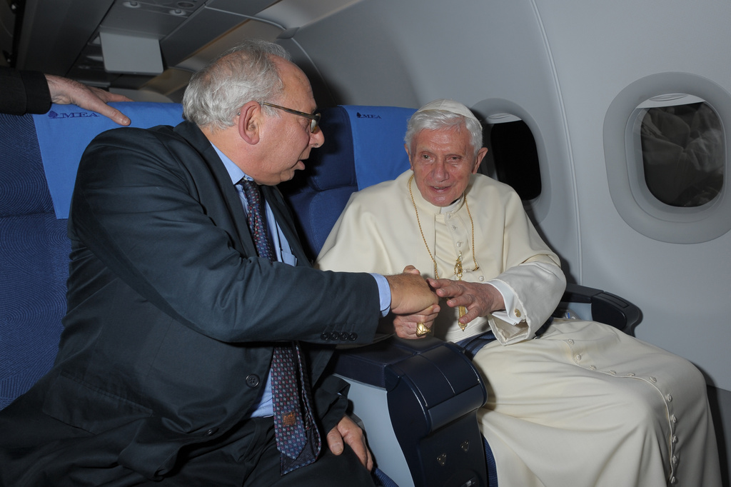 FILE - Rome Bureau Chief Victor Simpson, left, shakes hands with Pope Benedict XVI during the flight from Beirut to Rome, Sept. 16, 2012. (AP Photo/L'Osservatore Romano, File)