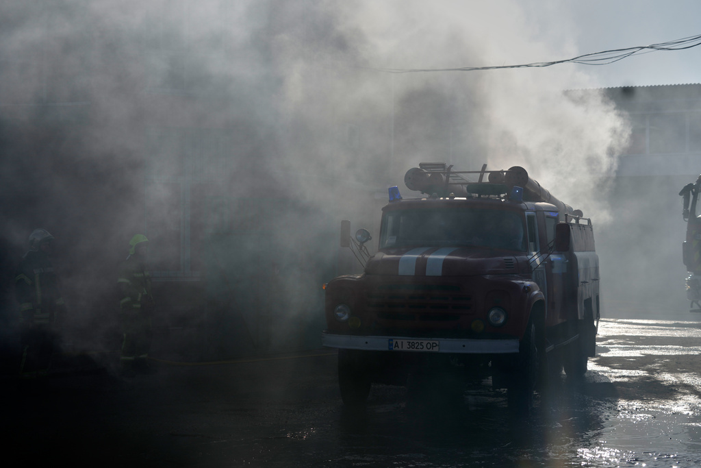 Firefighters put out the fire at a residential neighbourhood following a Russia missile and drone attack, in Brovary, close to Kyiv, Ukraine, Saturday, March 14, 2026. (AP Photo/Efrem Lukatsky)