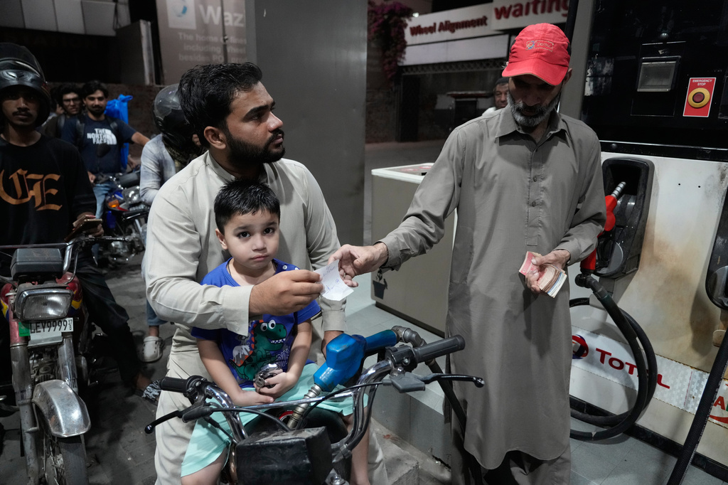 A motorcyclist gets fuel on subsidised rates in a recently government scheme for low income people, at a fuel station, in Lahore, Pakistan, Tuesday, Oct. 6, 2026. (AP Photo/K.M. Chaudary)