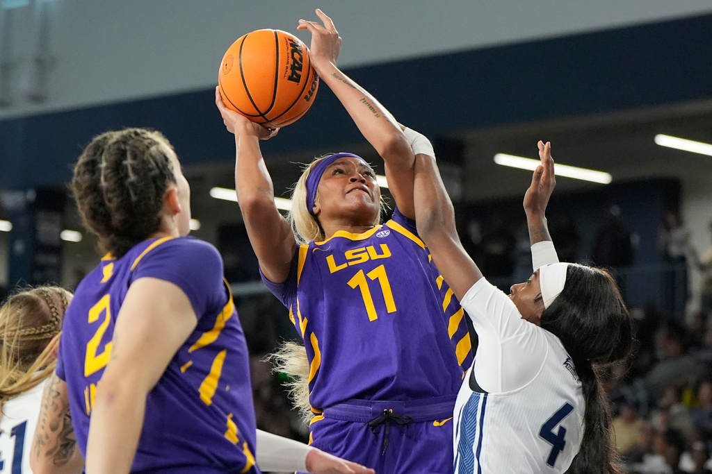 Louisiana State guard Zakiyah Johnson (11) drives against Georgia Southern guard Shanti Simmons (4) during the first half of an NCAA women's basketball game, Sunday, Nov. 9, 2025, in Statesboro. (AP Photo/Mike Stewart)